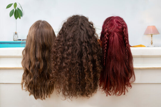 Back view of three sisters with long hair