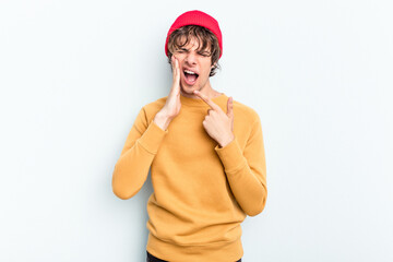 Young caucasian man isolated on blue background having a strong teeth pain, molar ache.