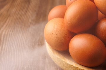 Wooden plate filled with eggs, wrapped in swirling smoke, symbolizing inflation and the financial strain on essential food.