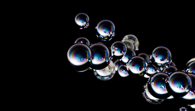 3D render of floating metallic spheres with reflections on a dark background