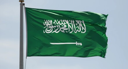 Saudi Arabia Flag Waving Against Blue Sky Representing National Pride
