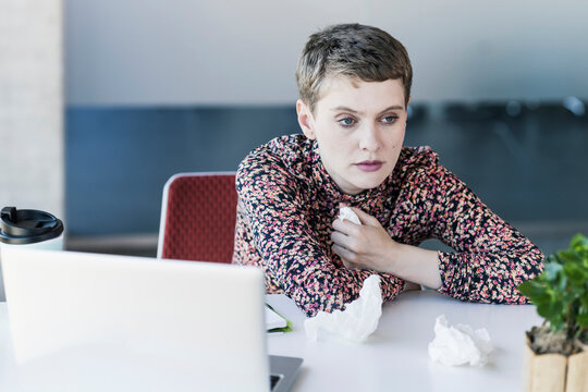 Ill businesswoman at desk in office