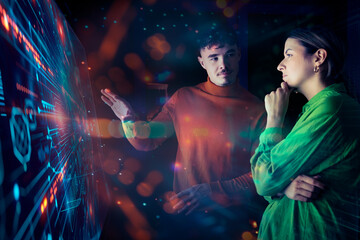 Two people collaborating on an augmented reality screen in a futuristic workspace