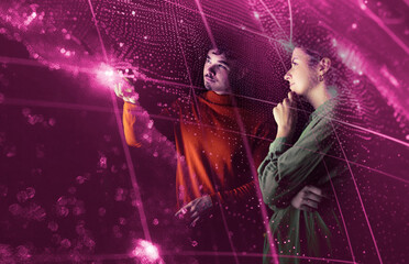 Two people interacting with augmented reality technology in a futuristic setting