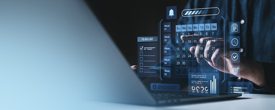 Businessman using futuristic digital calendar interface for scheduling and task management.