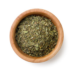 Dried tarragon in a wooden plate on a white background. Top view