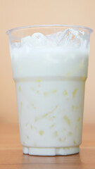 Vertical  Front view Close-up Iced Coconut Milk Dessert Drink.