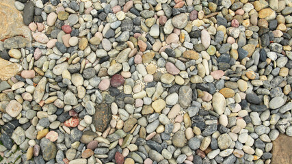 close-up view of crushed gray gravel, showcasing a rough and natural stone texture ideal for backgrounds, construction landscaping and industrial design elements.