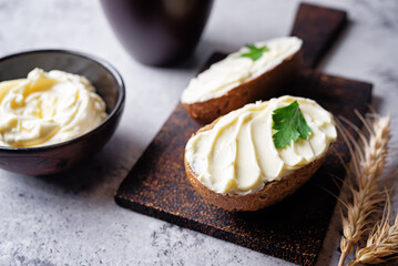 Rye buns with butter topping on a cutboard