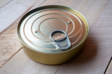 Round tin can with food on surface
