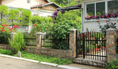 A view on a colorful garden in front of a house.