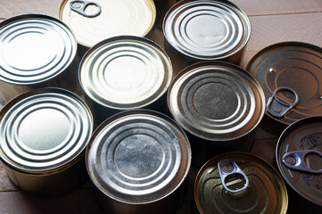 Round tin cans with food on the surface