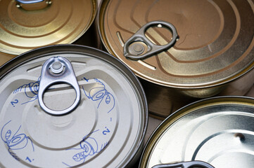 Round tin cans with food on the surface