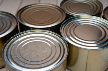 Round tin cans with food on the surface