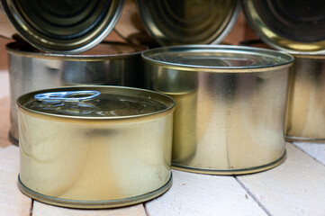 Round tin cans with food on the surface