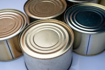 Round tin cans with food on the surface