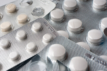 Medical tablets in blisters lie on the surface