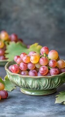Vibrant Red and Yellow Grapes in Green Bowl Still Life Photography