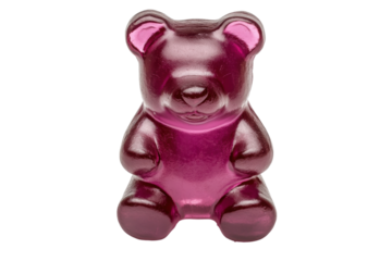 Large pink gummy bear candy isolated on black background, cut out