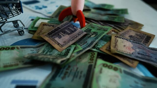 Bangladeshi Banknotes on Business Charts, A pile of Thai baht banknotes scattered over business charts and documents