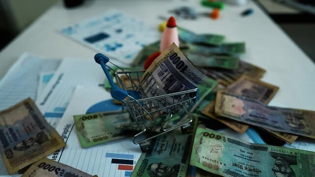 Bangladeshi Banknotes on Business Charts, A pile of Thai baht banknotes scattered over business charts and documents
