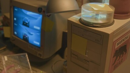 Close up of unrecognizable child putting CD disc into retro computer while playing videogame in nostalgic 90s setting, copy space