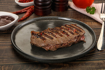 Grilled beef striploin steak with sauce