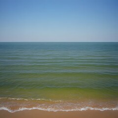 Obraz premium Serene Seascape, Calm Ocean Waves on Sandy Beach