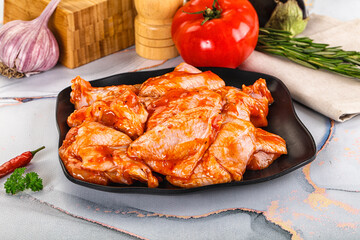 Raw marinated uncooked chicken wings