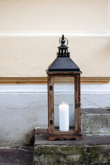 Vintage lantern with a candle placed on a doorstep in central Ljubljana