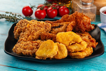 Golden crispy fried chicken mix - wings, drumsticks, nuggets and strips