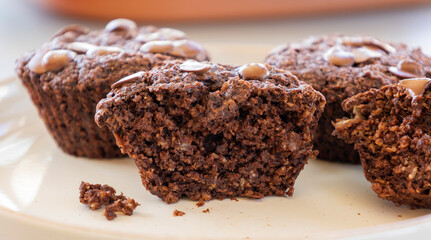  chocolate banana muffins on light background