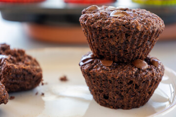  chocolate banana muffins on light background