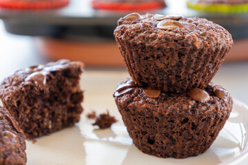  chocolate banana muffins on light background