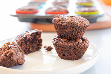  chocolate banana muffins on light background