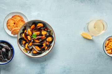 Mussels with toasted bread and a glass of white wine, overhead flat lay shot with copy space, menu design banner
