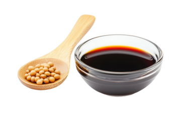 Soy sauce in glass bowl with wooden spoon and soybeans on white background, cut out