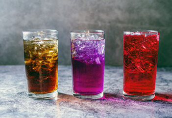 A lot of Soft drinks in colorful and flavorful glasses on the table,Glasses with sweet drinks with ice cubesv