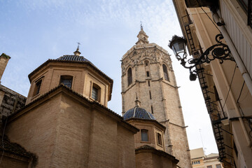 Valencia Cathedral and Miguelete Tower (Micalet) from Plaza de la Reina, Spain. A Gothic masterpiece standing tall, framed by the lively ambiance of one of Valencia&rsquo;s most iconic squares.