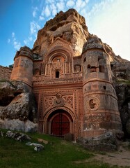 A majestic, weathered fortress carved from a colossal mountain