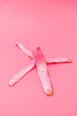 Striking banana peel art arrangement on a vibrant pink background