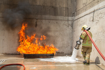 a firefighter who puts out fires with foam for public education and demonstration to ordinary people for public education