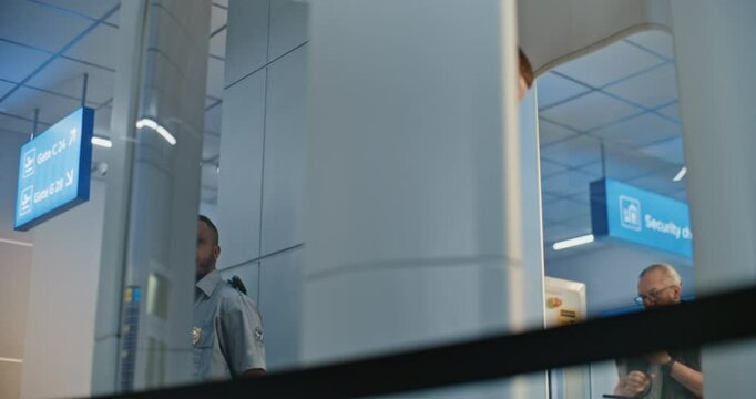 Security Checkpoint: Man with Bionic Prosthetic Leg Walking Through X-ray Metal Detector Scanner in Airport Terminal. Passenger Screening Procedures for Boarding Flight. Traveler with Disability.
