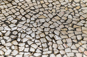 Mosaic floor showcases an intricate arrangement of stone pieces, revealing a blend of colors and shapes.