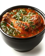 Fototapeta premium Captivating closeup of hearty chicken drumstick stew with fresh herbs in a black bowl on white backdrop offering a rich and flavorful culinary experience
