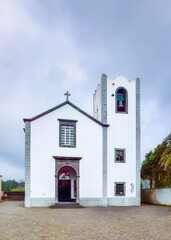 Igreja de Sao Martinho, Funchal, white church with bell tower, cross atop roof, stone arch entrance, overcast sky, historic architecture shines.. For travel backgrounds, heritage posters, copy space