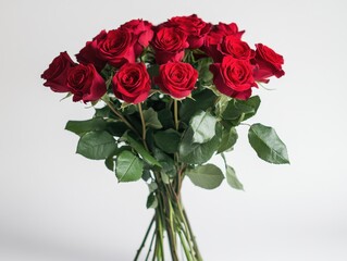 Elegant bouquet of deep red roses against a soft white background romantic floral arrangement for love