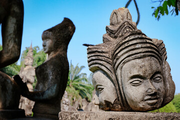 Visit to Buddha Park in Vientiane Laos showcasing unique sculptures against a clear blue sky