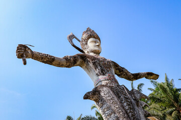 Visit Buddha Park featuring unique sculptures in Vientiane Laos under bright blue sky