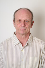 Obraz premium Senior man with a cotton shirt against white wall